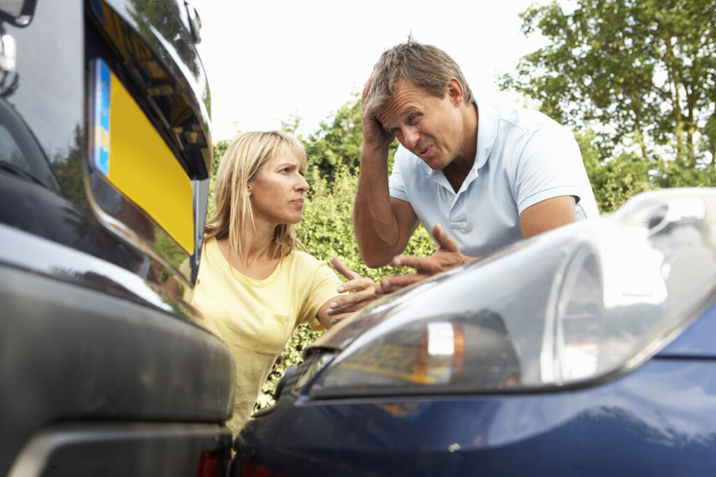 Man And Woman Having Argument After Traffic Accident