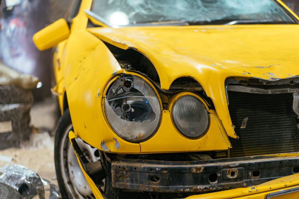 Close up of a Yellow car glass damage caused by accident.